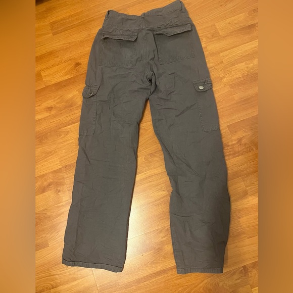 Grey cargos with pockets all over the front of it and visible grey seams. - Picture 4 of 5